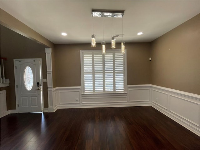 foyer entrance featuring a wainscoted wall, dark wood-type flooring, and recessed lighting