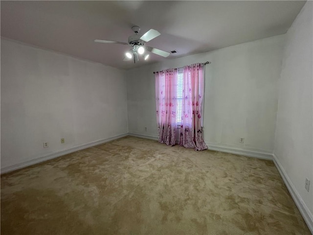 carpeted empty room featuring ceiling fan