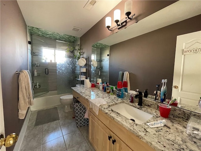 full bathroom with tile patterned flooring, vanity, toilet, and shower / bath combination with glass door