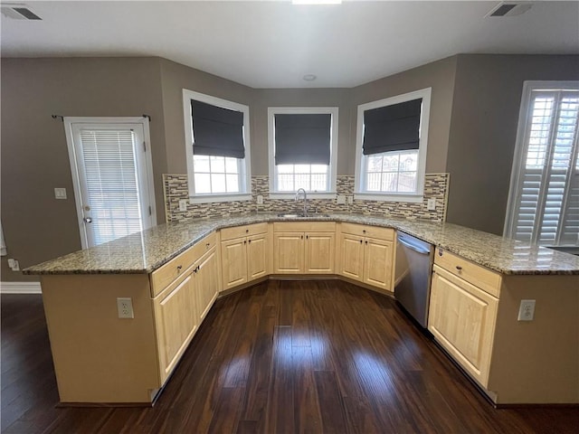 kitchen featuring light stone counters, a peninsula, visible vents, stainless steel dishwasher, and light brown cabinetry