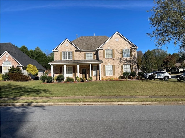 view of front facade with a porch and a front yard