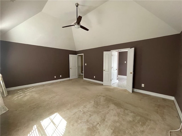 interior space featuring high vaulted ceiling, carpet flooring, baseboards, and a ceiling fan