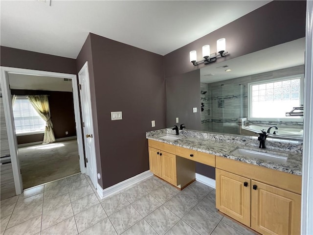 bathroom with a healthy amount of sunlight, a sink, and a shower stall