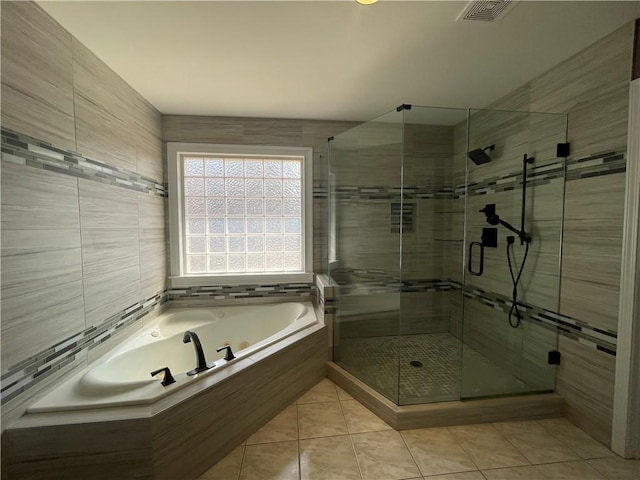 full bathroom with tile patterned flooring, tile walls, visible vents, a shower stall, and a whirlpool tub