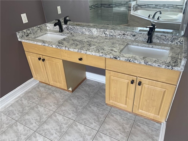 full bathroom featuring double vanity, tile patterned flooring, and a sink