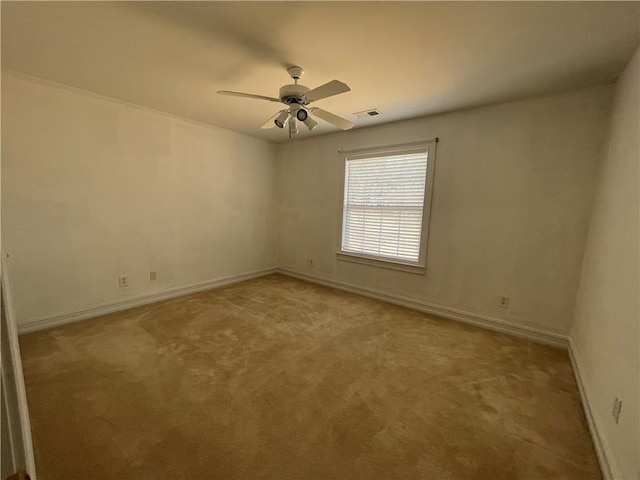 empty room with ceiling fan, baseboards, visible vents, and light colored carpet