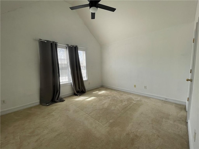 empty room featuring baseboards, high vaulted ceiling, ceiling fan, and light colored carpet