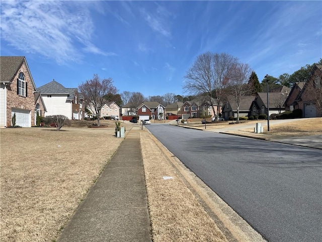 view of street featuring sidewalks, a residential view, and curbs