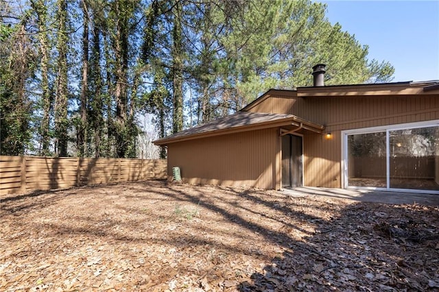 rear view of house featuring fence