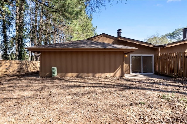 view of side of home with fence