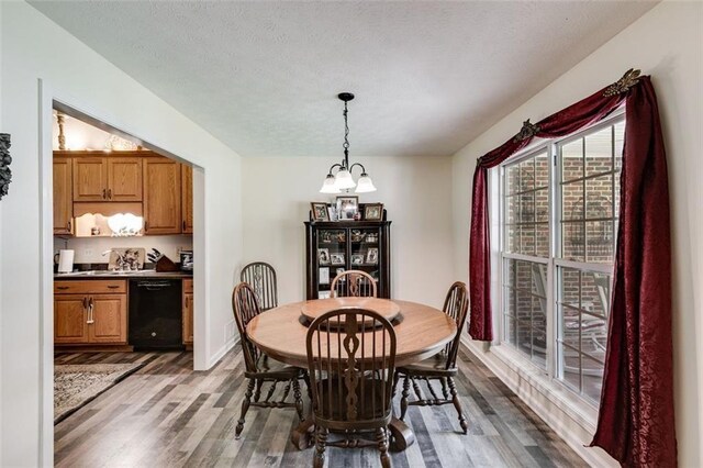 144 Bobs Dr SW, Mableton, GA 30126 - dining space with a textured ceiling, an inviting chandelier, and wood finished floors