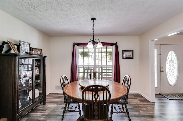 144 Bobs Dr SW, Mableton, GA 30126 - dining area with visible vents, baseboards, dark wood-style floors, a notable chandelier, and a textured ceiling