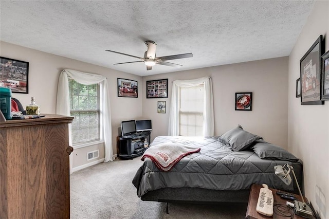144 Bobs Dr SW, Mableton, GA 30126 - carpeted bedroom with visible vents, a textured ceiling, baseboards, and a ceiling fan