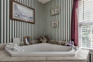 144 Bobs Dr SW, Mableton, GA 30126 - bathroom featuring wallpapered walls and a bath