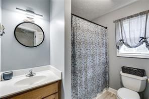 144 Bobs Dr SW, Mableton, GA 30126 - bathroom with curtained shower, toilet, vanity, and wood finished floors