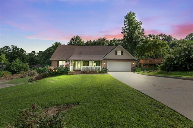 144 Bobs Dr SW, Mableton, GA 30126 - view of front facade featuring a lawn, driveway, a porch, an attached garage, and brick siding