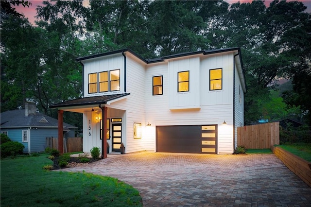 156 Martha Ave NE, Atlanta, GA 30317 - contemporary home with board and batten siding, a garage, and decorative driveway