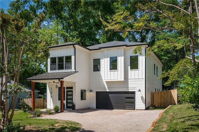156 Martha Ave NE, Atlanta, GA 30317 - view of front of property featuring board and batten siding, an attached garage, decorative driveway, and a standing seam roof