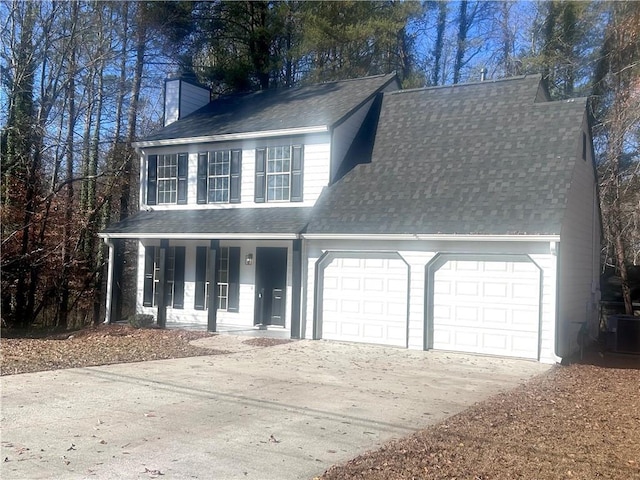 view of front facade featuring a porch, a garage, and central AC