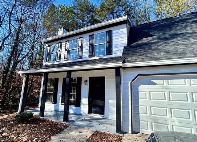 view of front of house featuring covered porch and a garage