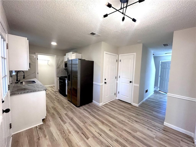 kitchen featuring light hardwood / wood-style floors, white cabinetry, sink, and appliances with stainless steel finishes