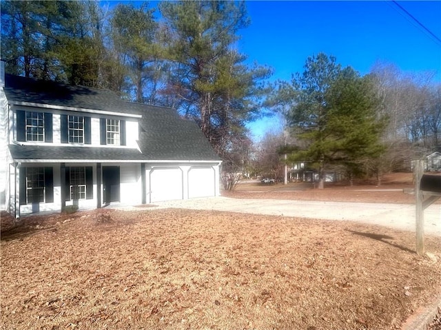 exterior space with a porch and a garage