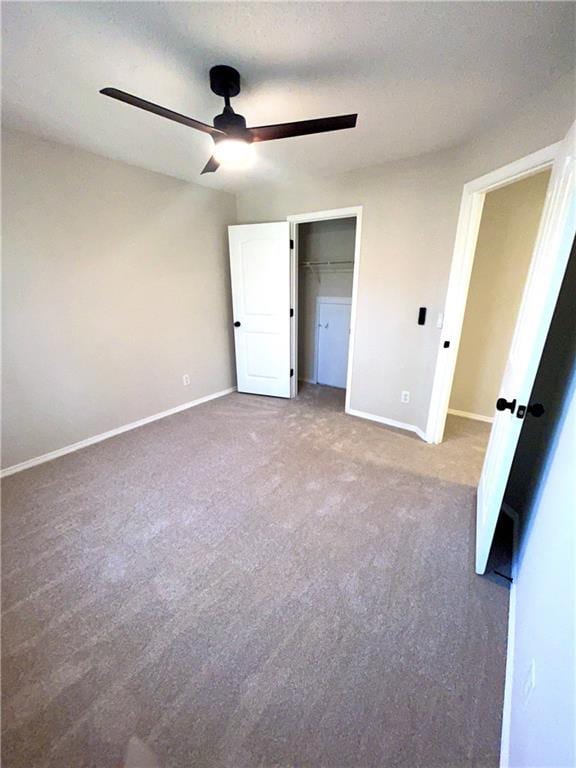 unfurnished bedroom featuring carpet flooring, a closet, and ceiling fan