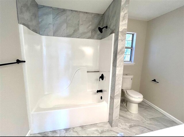 bathroom with toilet and shower / washtub combination