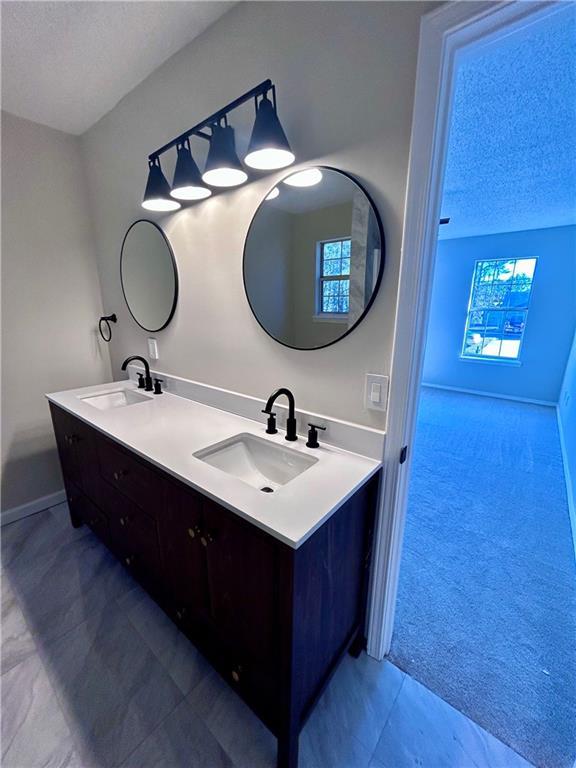 bathroom featuring vanity and a textured ceiling