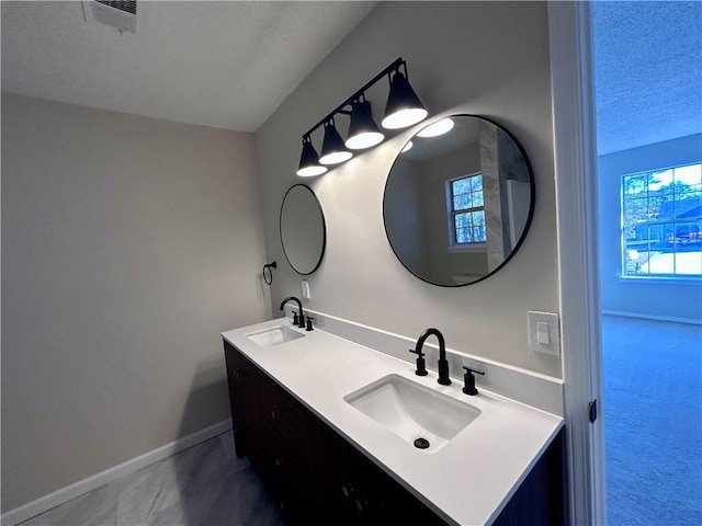 bathroom with a textured ceiling and vanity