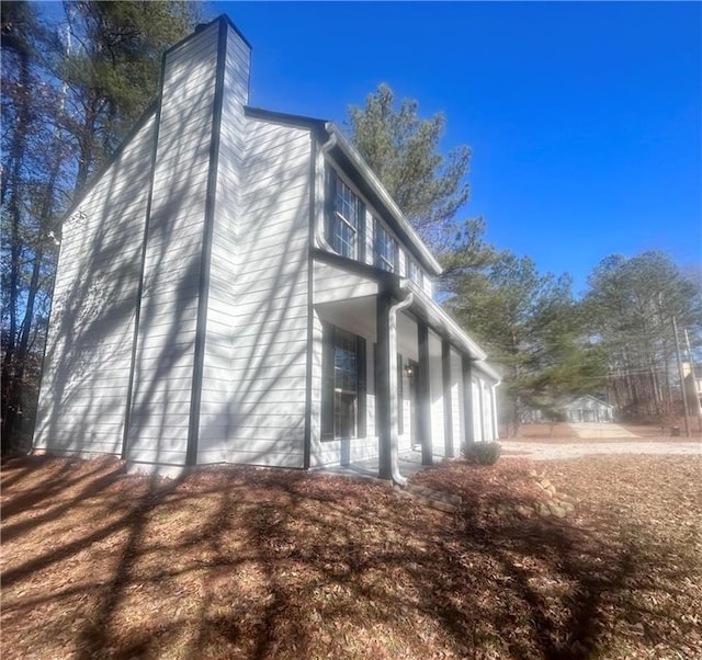 view of property exterior featuring a porch