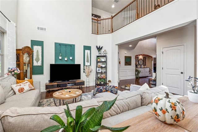 living room featuring a high ceiling and hardwood / wood-style flooring