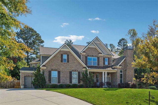 craftsman house with a front yard and a garage