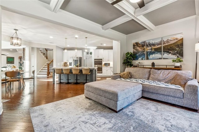 living room with crown molding, dark hardwood / wood-style floors, beam ceiling, and coffered ceiling