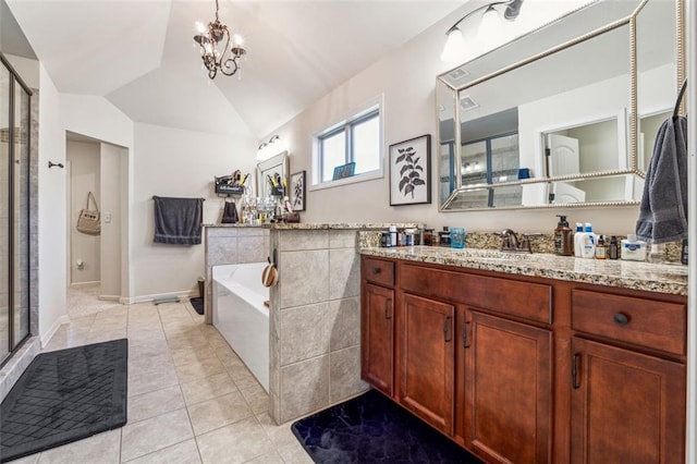 bathroom featuring vanity, shower with separate bathtub, lofted ceiling, and tile patterned flooring