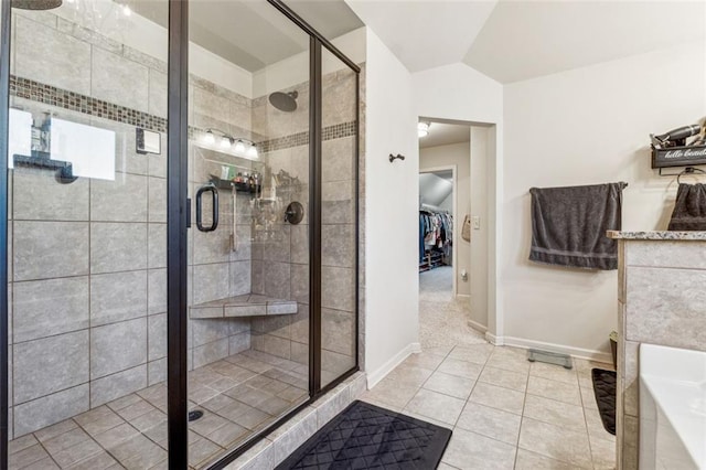 bathroom featuring lofted ceiling, plus walk in shower, and tile patterned flooring