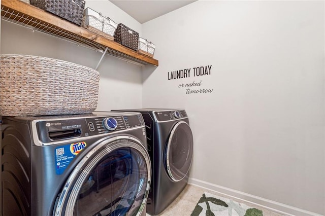 laundry room featuring light colored carpet and washing machine and dryer