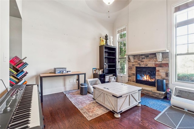 living room featuring a wealth of natural light and dark hardwood / wood-style flooring