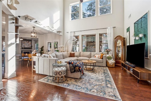 living room with a healthy amount of sunlight and dark wood-type flooring