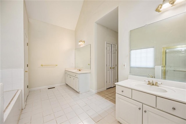 205 Finsbury Park Ct, Suwanee, GA 30024 - full bath with two vanities, tile patterned floors, a garden tub, vaulted ceiling, and a shower stall
