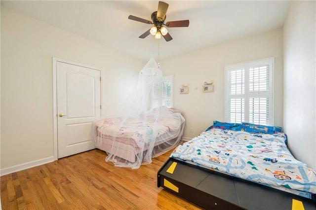 205 Finsbury Park Ct, Suwanee, GA 30024 - bedroom with multiple windows, light wood finished floors, and ceiling fan