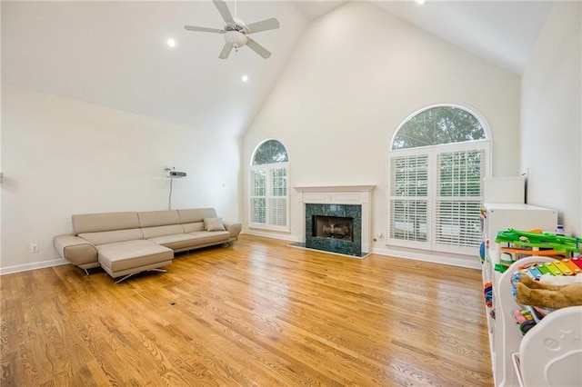 205 Finsbury Park Ct, Suwanee, GA 30024 - living area featuring high vaulted ceiling, a ceiling fan, wood finished floors, a fireplace, and recessed lighting