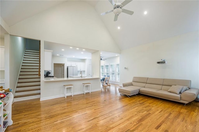 205 Finsbury Park Ct, Suwanee, GA 30024 - living room with a ceiling fan, high vaulted ceiling, light wood-style flooring, stairway, and recessed lighting