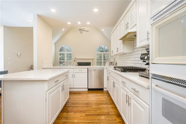 205 Finsbury Park Ct, Suwanee, GA 30024 - kitchen with stainless steel appliances, a ceiling fan, vaulted ceiling, light countertops, and recessed lighting