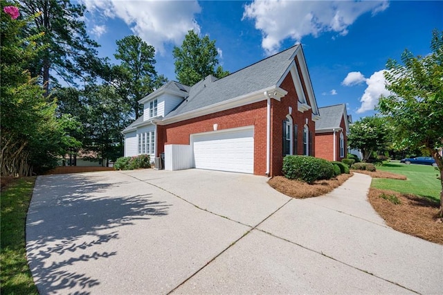205 Finsbury Park Ct, Suwanee, GA 30024 - view of home's exterior featuring concrete driveway, an attached garage, and brick siding