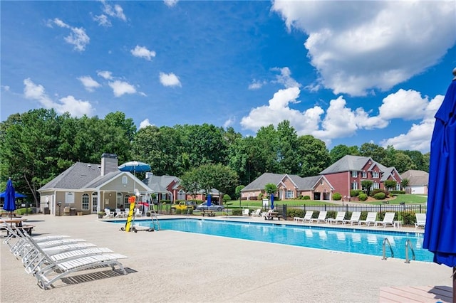 205 Finsbury Park Ct, Suwanee, GA 30024 - community pool featuring a patio and view of scattered trees