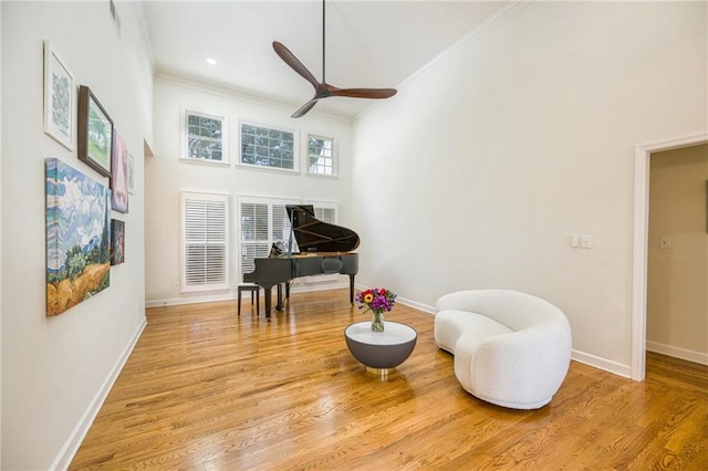 205 Finsbury Park Ct, Suwanee, GA 30024 - living area with ornamental molding, a ceiling fan, wood finished floors, and a high ceiling