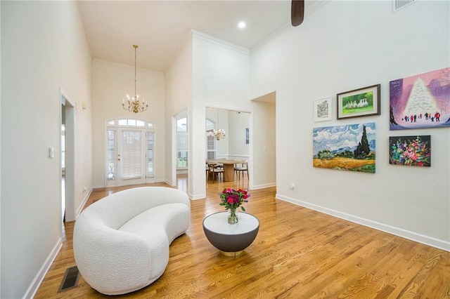 205 Finsbury Park Ct, Suwanee, GA 30024 - sitting room with a chandelier, a high ceiling, crown molding, wood finished floors, and recessed lighting