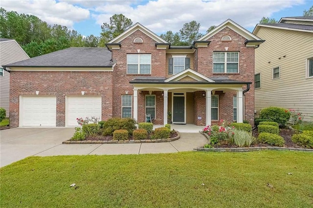 view of front of house with covered porch, a garage, brick siding, driveway, and a front yard