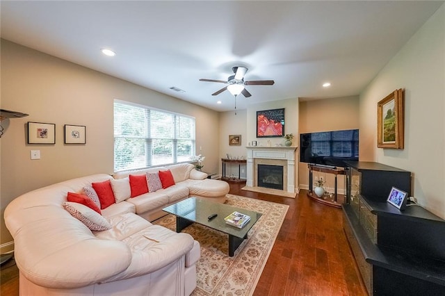 living area with ceiling fan, recessed lighting, a fireplace with flush hearth, visible vents, and dark wood-style floors